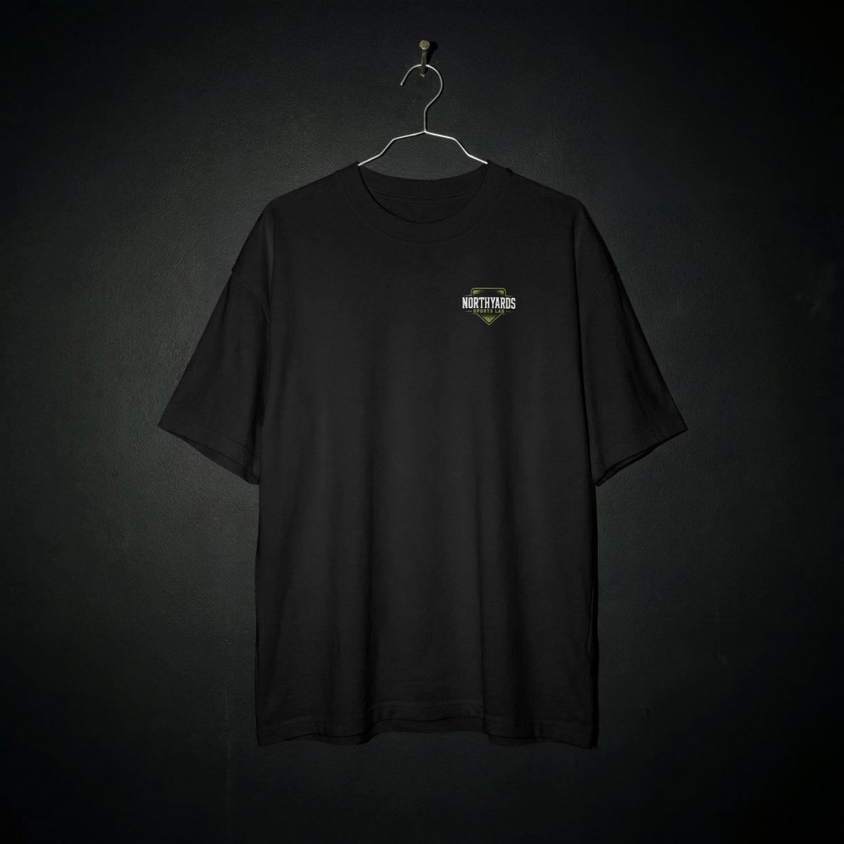 Home Field Tee front – Northyards Sports Lab badge on the left chest of a black tee