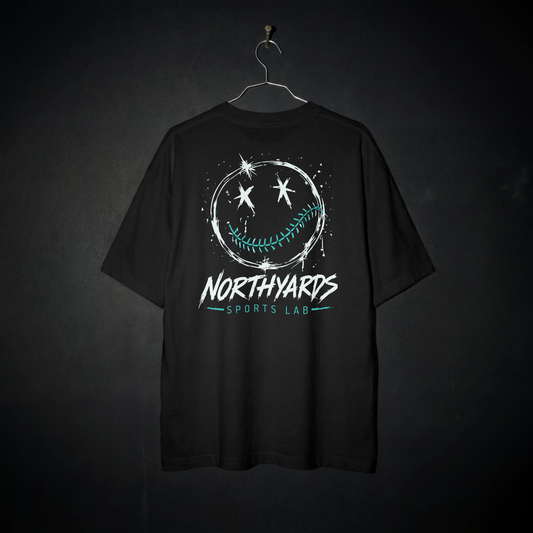 Smiley 1.0 Tee back – distressed white smiley face with crossed-out eyes and teal baseball-stitched smile above Northyards Sports Lab lettering