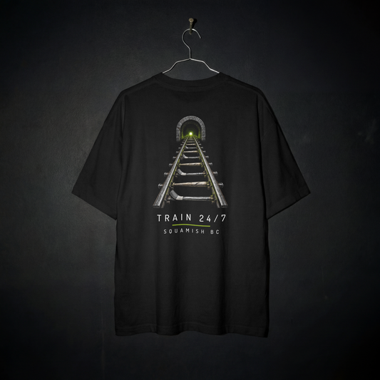 Train Yard Tee back – railway tracks with baseball bat and hockey stick ties leading into a tunnel, with Train 24/7 and Squamish BC lettering